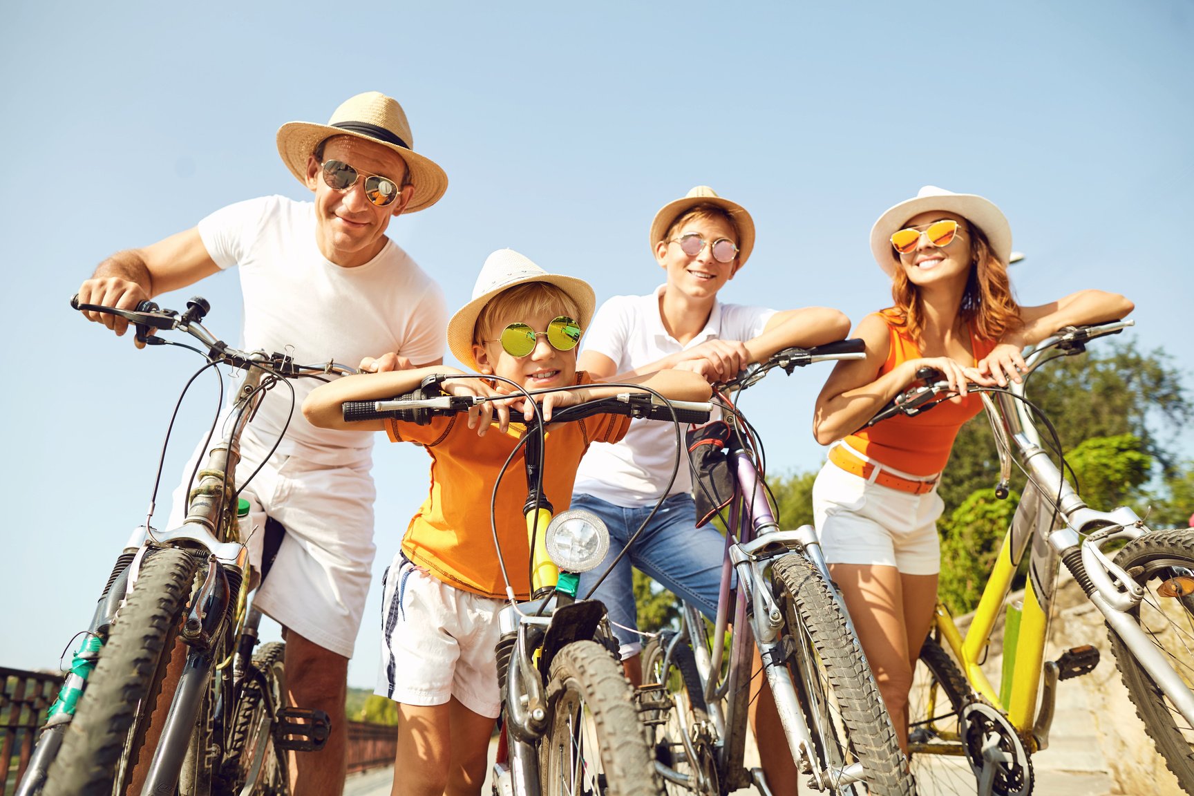 Happy Family on Bicycles for a Walk in Park.