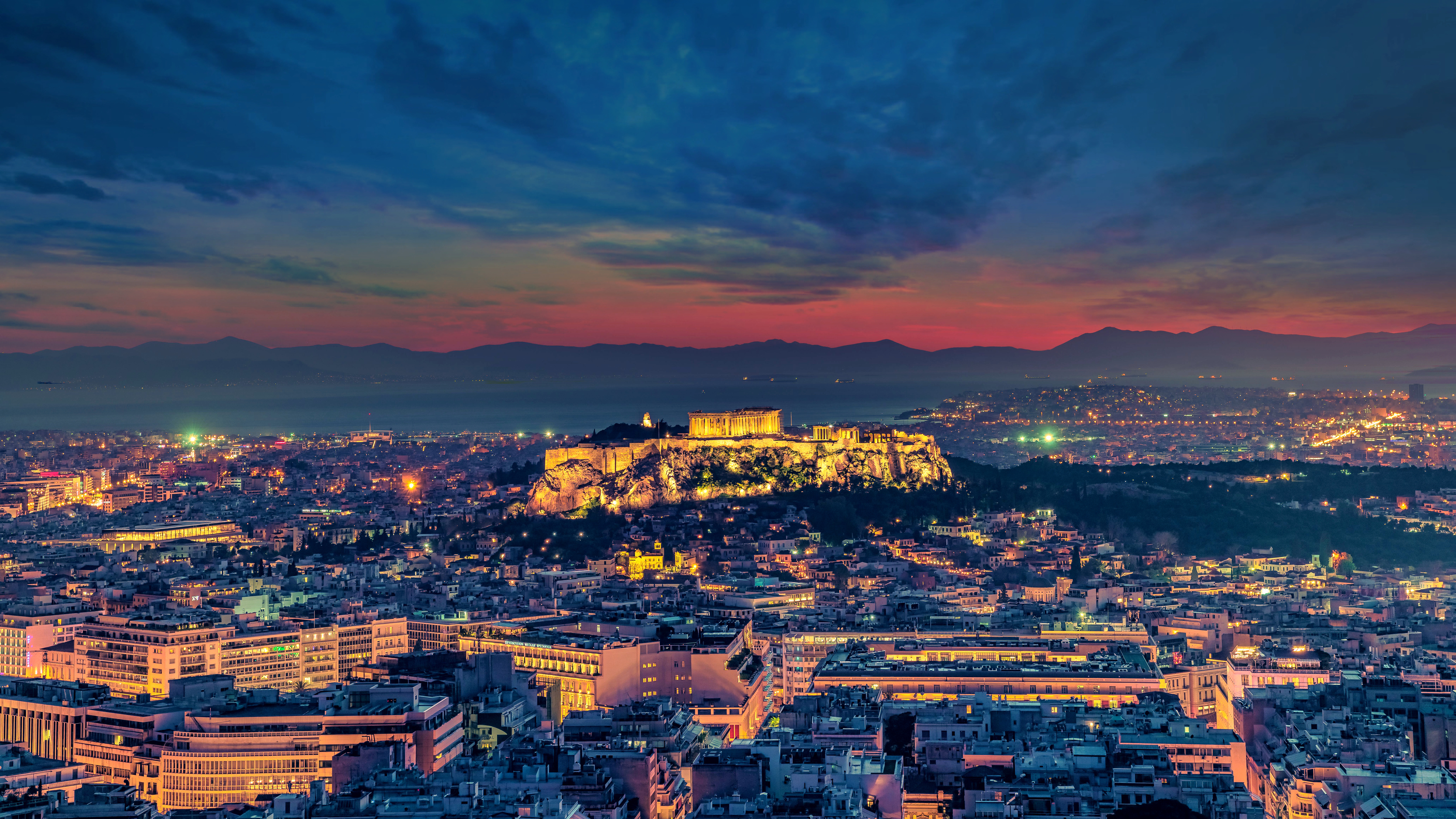 City With High Rise Buildings Under Orange and Blue Sky