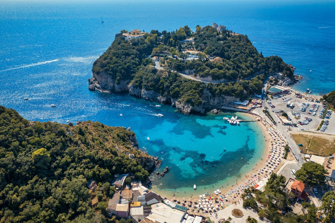 Picturesque seaside of Paleokastritsa, Corfu, Greece. Beautiful bay in Paleokastritsa in Corfu island, Greece. Panoramic view of Palaiokastritsa, boats and beach Corfu, Greece